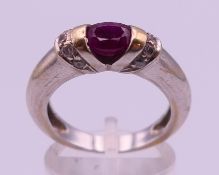 A 14ct white gold ruby ring . Ring size O/P. 6.2 grammes total weight.