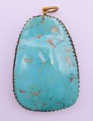 A large turquoise pendant. 7 cm high.