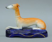 A circa 1860 Staffordshire porcelain greyhound inkwell. 17 cm long.