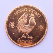 A boxed 1981 Lunar Year of the Cockerel 22 ct gold Hong Kong 1000 dollar coin. 15.98 grammes, 28.