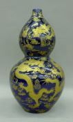 A Chinese porcelain double gourd vase decorated with dragons. 43 cm high.