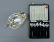 A silver sauce boat and a boxed set of six silver-plated teaspoons. The former 15 cm long and 140.