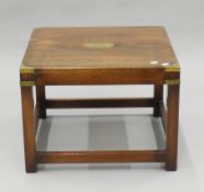 A mahogany campaign-style coffee table. 56 cm wide.