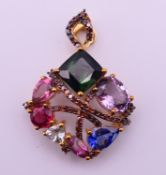 A 9 ct gold and multi-gemstone pendant. 3 cm high. 4.4 grammes total weight.
