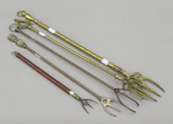 A 19th century telescopic toasting fork and four brass toasting forks.