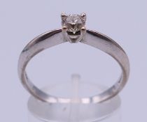 An 18 K white gold solitaire diamond ring, the diamond 0.