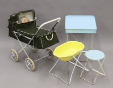 A vintage child's dolls pram, a child's school desk and stool and a baby's bath.