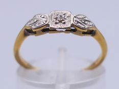 An 18 ct gold and diamond ring. Ring size L/M. 1.7 grammes total weight.