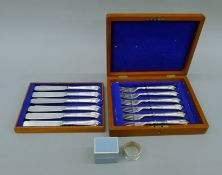 A boxed National Trust silver napkin ring and a canteen of silver-plated fish cutlery.