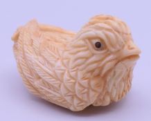 A carved bone duck netsuke. 4.5 cm long.