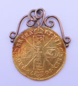 A Charles II 1679 gold Guinea with unmarked scrolled pendant mount. 3.5 cm high including mount. 9.