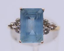 An 18 ct gold, aquamarine and diamond ring. Ring size O/P. 3.2 grammes total weight.
