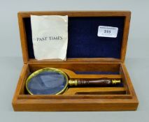 A boxed Past Times magnifying glass. The box 21 cm wide.
