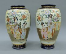 A pair of late 19th/early 20th century large Satsuma vases with figural decoration. Each 31 cm high.