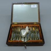 A 19th century Continental brass-inlaid rosewood box containing silver spoons and tongs. The box 19.