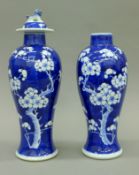 A pair of 19th century Chinese blue and white porcelain baluster vases, one with lid,