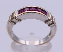 An 18 K white gold, ruby and diamond (0.15 carat) ring. Ring size P. 6.2 grammes total weight.