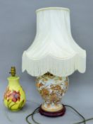 A Moorcroft porcelain lamp and another porcelain lamp. The former 30 cm high.
