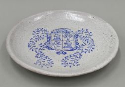 A large 19th century Oriental pottery crackleware dish painted with a Spanish armorial crest.