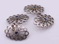 A pair of unmarked platinum and sapphire cufflinks, in an Asprey box. 1.7 cm high. 9.