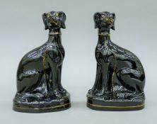 A pair of circa 1850 Staffordshire porcelain Jackfield-type lurchers/hounds. Each 20 cm high.