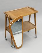 A mid-20th century tea trolley and a mid-20th century wall mirror. The former 71 cm wide.