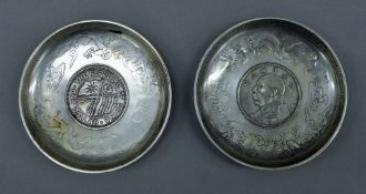 Two Chinese white metal coin dishes. 9.5 cm diameter.