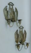 A pair of bronze bat-form wall sconces. 25 cm wide.