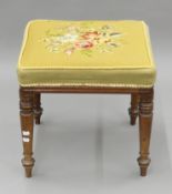 A Victorian tapestry-topped stool. 47 cm wide.