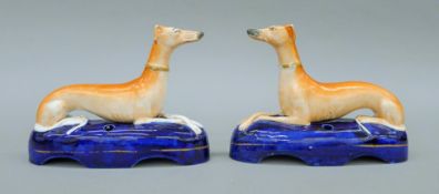 A pair of circa 1860 Staffordshire porcelain greyhound inkwells. Each 18 cm long.