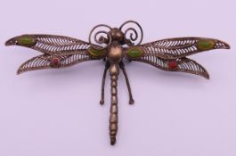 A metal dragonfly with filigree wings. 12.5 x 6.5 cm.