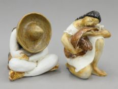 A pair of Spanish pottery figures formed as Mexicans. The larger 18 cm high.