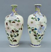 A pair of late 19th century Satsuma vases with floral decoration. Each 30 cm high.