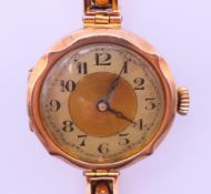 A 9 ct gold scalloped edge cased ladies wristwatch on a 9 ct gold bracelet marked 'Bon Marche'. 2.