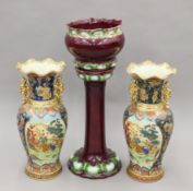 A jardiniere on stand and a pair of Japanese vases. The former 82 cm high.