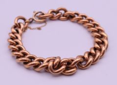 A 9 ct gold curb link bracelet. Approximately 18 cm long. 16.9 grammes.