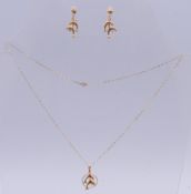 A pair of 9ct gold dolphin earrings and a 9ct gold dolphin pendant on a 9 ct gold chain. Earrings 2.