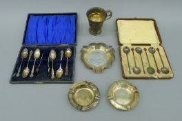 Three silver ashtrays, a cased set of silver teaspoons and tongs,
