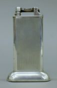 A 1930's silver-plated Dunhill lift-arm tallboy table lighter. 10 cm high.