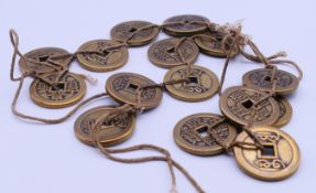 A quantity of Chinese metal coins. 3.2 cm diameter.