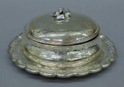 A Garrards silver butter dish on stand, with blue glass liner. The stand 20 cm diameter and 637.
