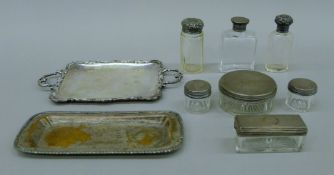 A quantity of silver-mounted jars, including some by Asprey, and two small silver-plated trays.