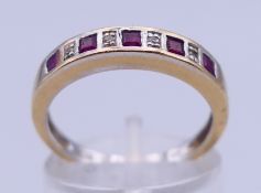 An 18 K gold nine-stone ruby and diamond ring. Ring size N/O. 3.4 grammes total weight.