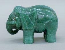 A carved jade model of an elephant. 10 cm long.