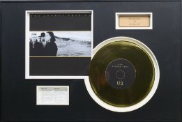 A U2 gold disc display for The Joshua Tree, framed and glazed. 40 x 60 cm.