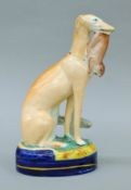 A circa 1860 Staffordshire porcelain greyhound. 25 cm high.