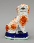 A 19th century Staffordshire pottery spaniel. 21 cm high.