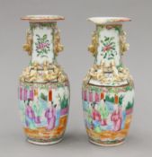 A pair of small 19th century Canton porcelain vases. Each 21 cm high.