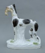 A Victorian Staffordshire coursing greyhound. 28 cm high.