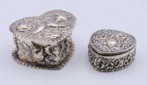 Two embossed heart shaped silver boxes. The larger 8 cm wide.